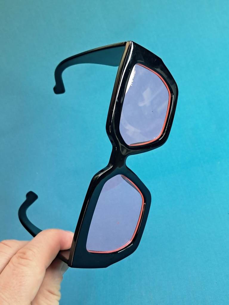 These are black oversized square sunglasses with purple tinted lenses.