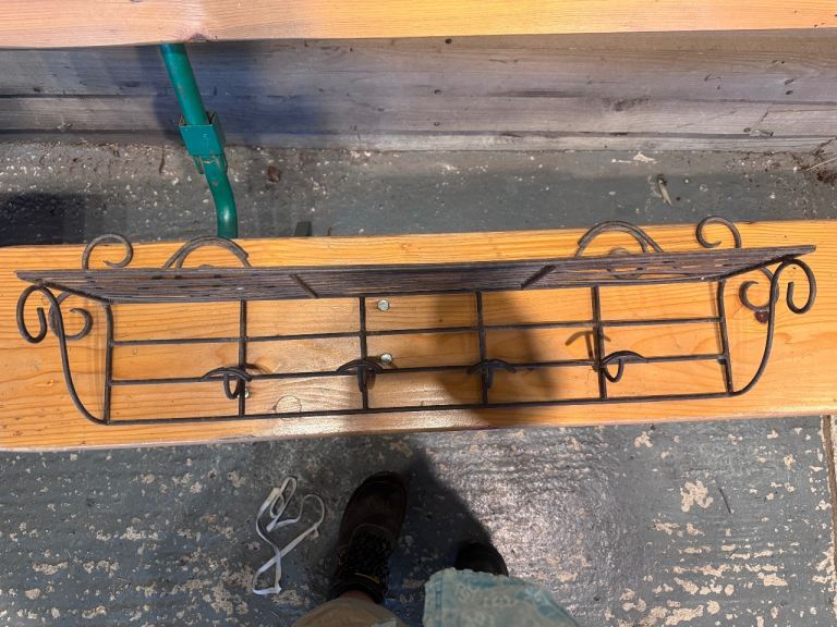 Vintage metal shelf with integrated hooks