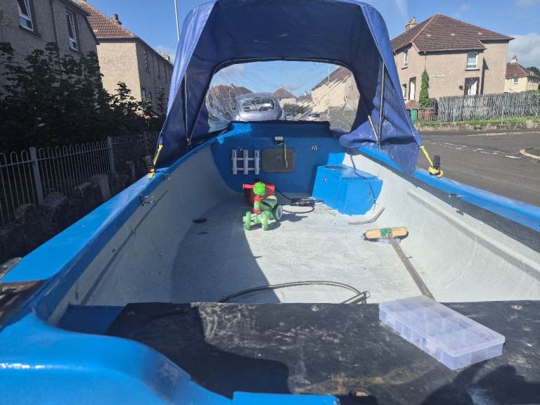 Small Blue and White Fishing Boat with Canopy