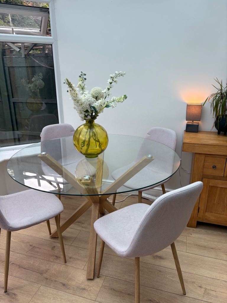 Glass Dining Table with Light Wood Base & Four Pink Chairs
