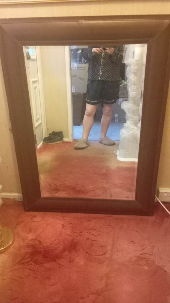 Mirror with brown leather around esdge