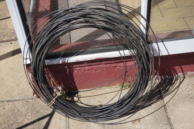 Many metres of black garden wire .