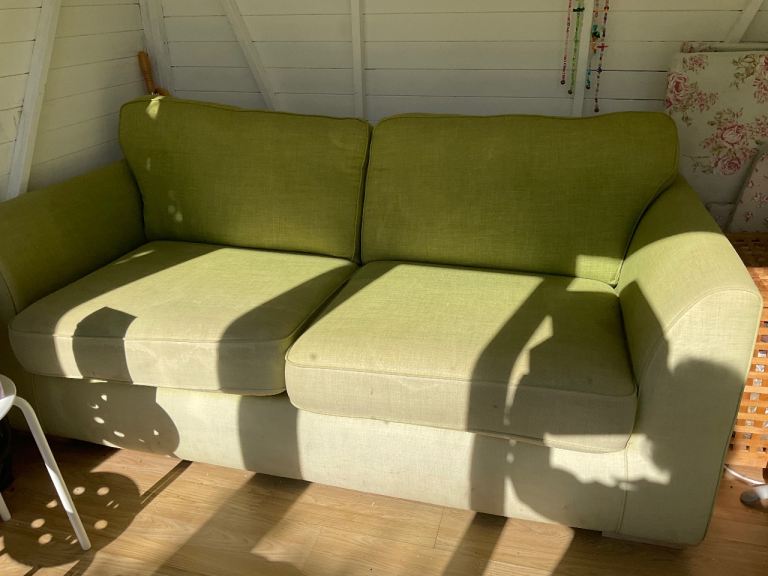 Green 2 seater sofa, used in garden room