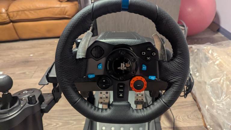 Logitech G29 steering wheel, pedals and manual shifter, with mount frame.