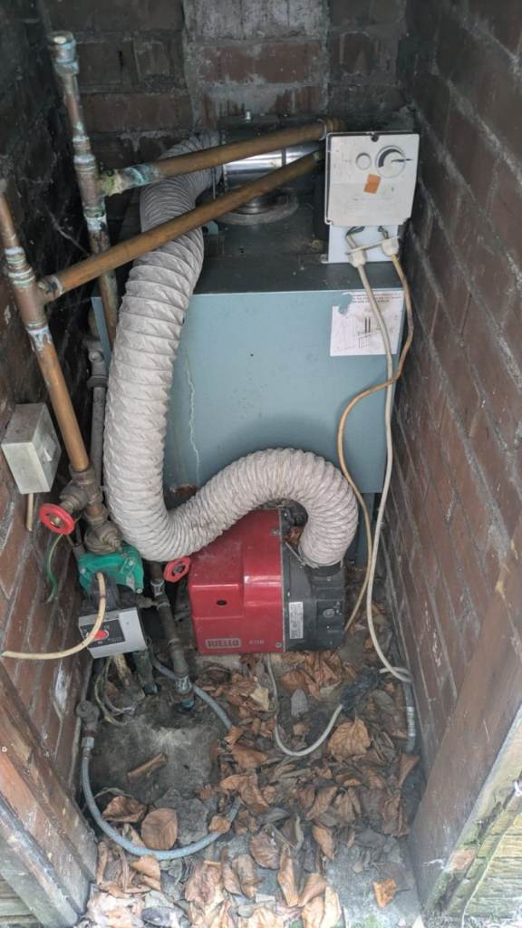 Old Central Heating Boiler Unit with Pipework