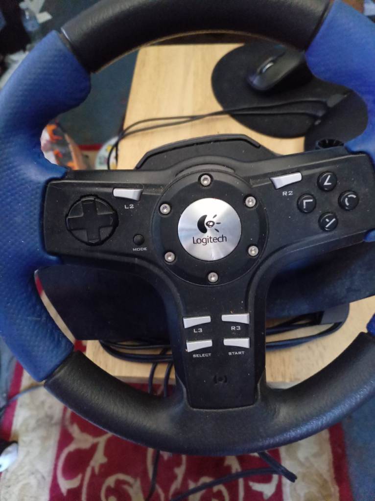 Blue Logitech steering wheel and pedal
