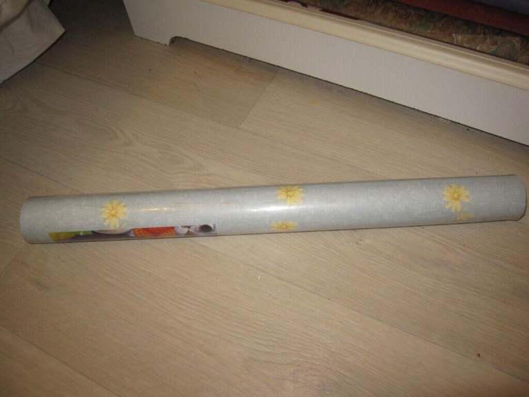 Roll of blue wall paper with yellow flowers brand new and sealed