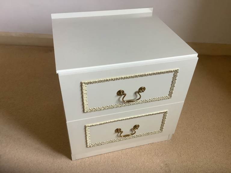  Bedside Cabinet with golden ornate drawer fronts.