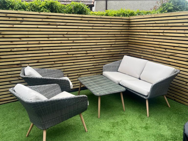 Grey rattan garden furniture set with glass table 