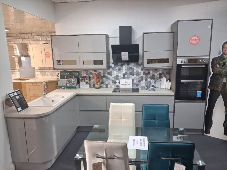 Stunning ex-display J-Pull handleless fitted kitchen in a grey gloss, with a stone effect worktop.