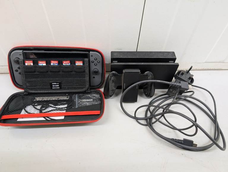 Origional Nintendo Switch (inc. Joycon Control holder, Charging Dock + Misc Games)