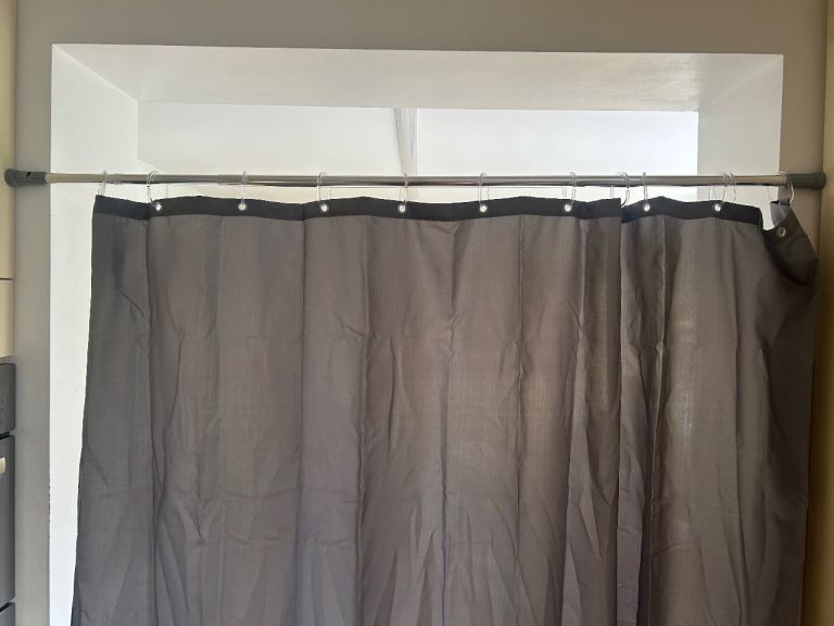Extendable curtain pole with shower curtain 