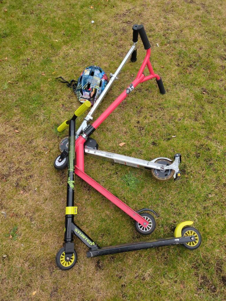Three kids scooters and helmet