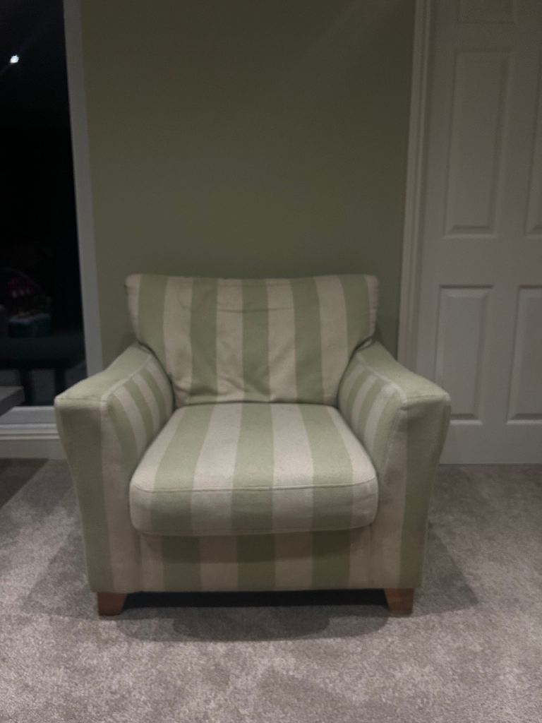 Natural beige coloured fabric striped armchair with medium coloured oak legs 