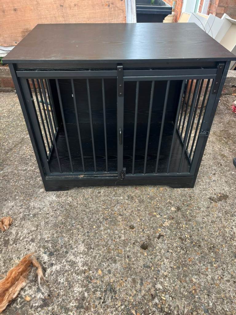 Black wooden dog crate with sliding door