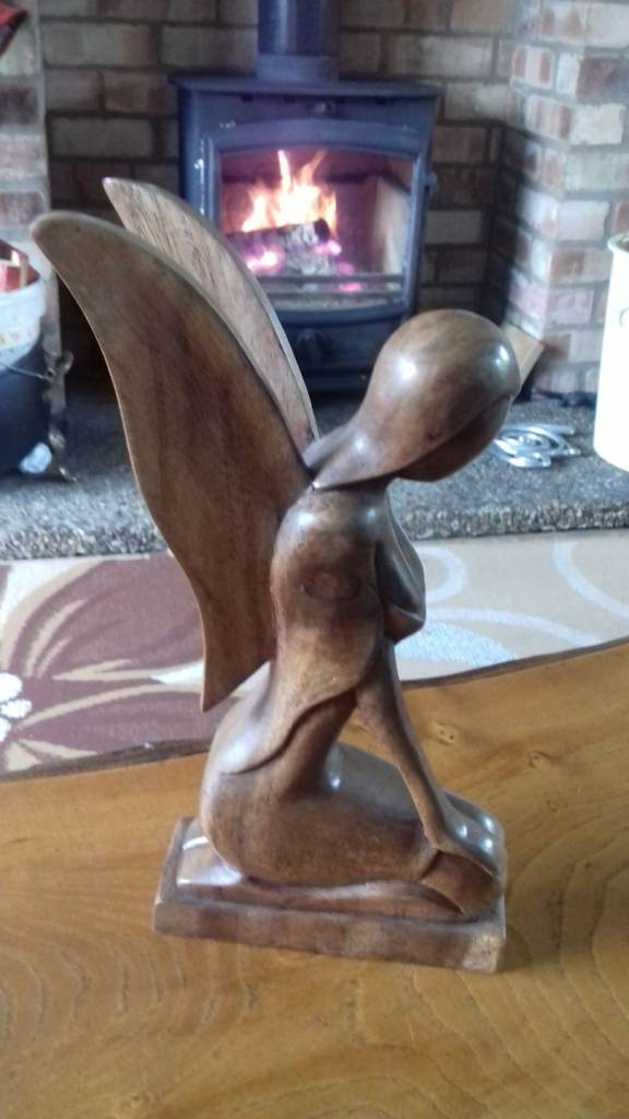 Wooden Seated angel and singing monk