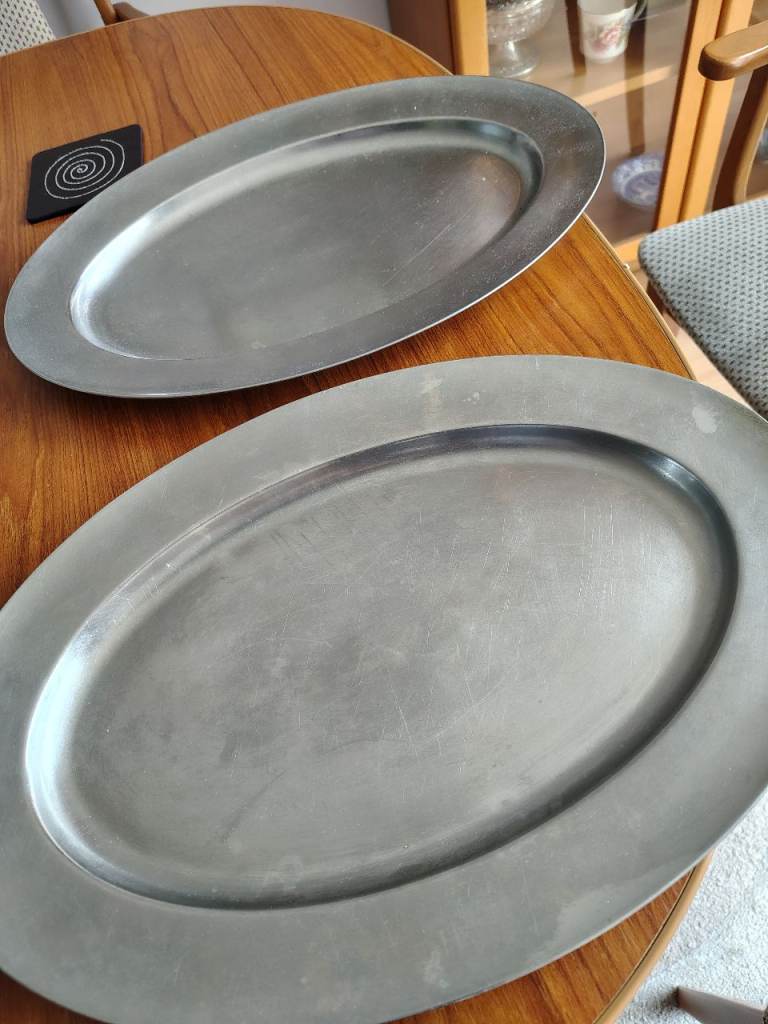 Two large metal serving platters