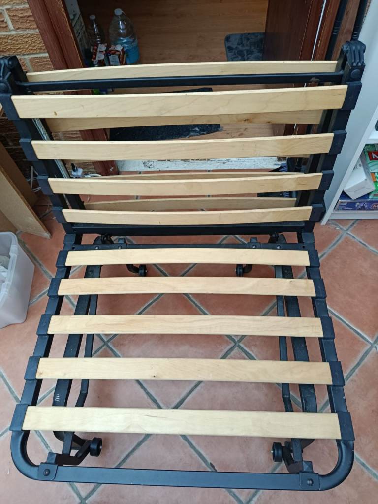 IKEA folding chair bed with metal frame, wooden slats and mattress.