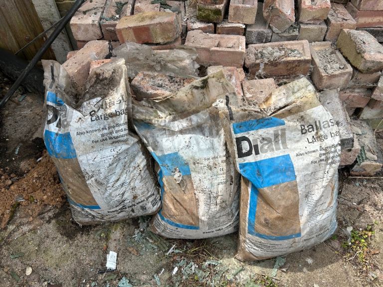 3 Diall ballast bags (25kg each) and a stack of bricks for free