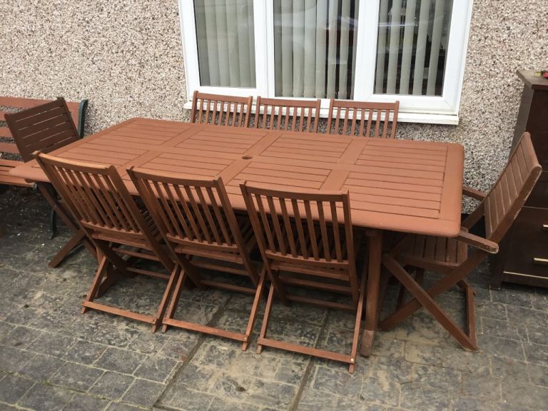 Large teak garden table and8 folding teak chairs 