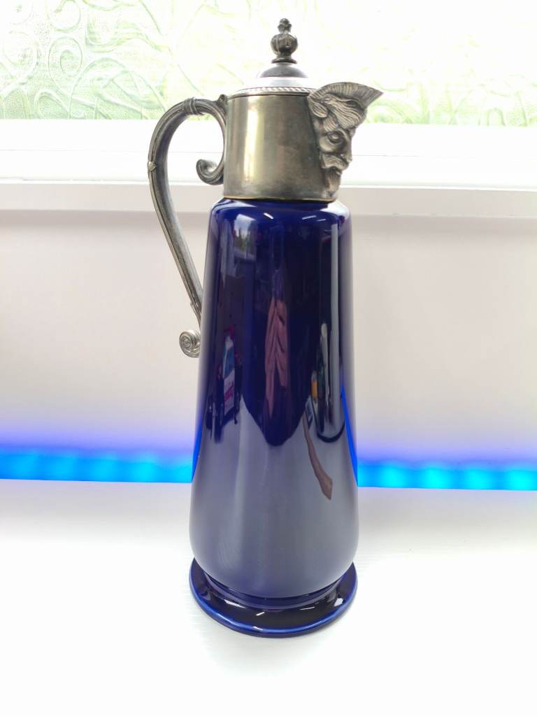 vintage WADE cobalt blue claret jug featuring silver-plated fittings and a Bacchus mask spout. 