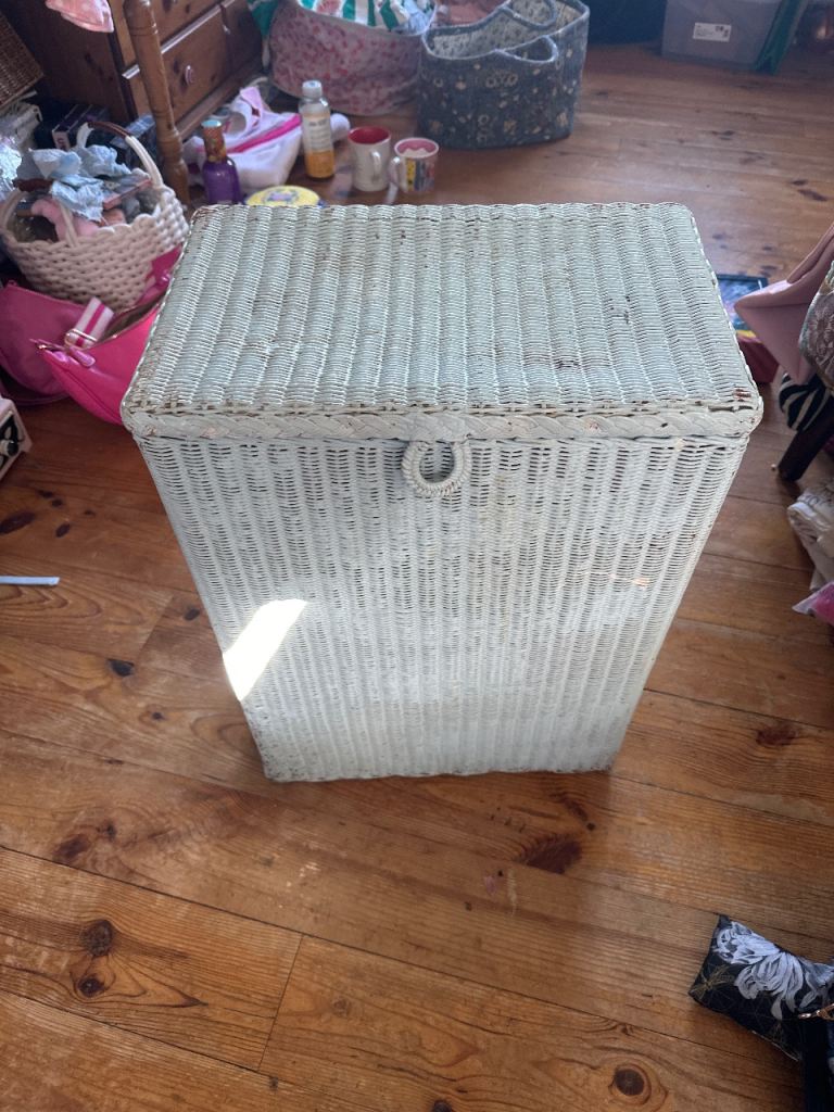 A lovely white wicker laundry basket
