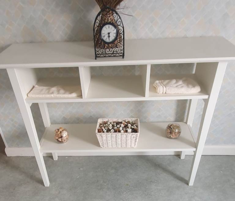White wooden unit currently used as bathroom furniture 
