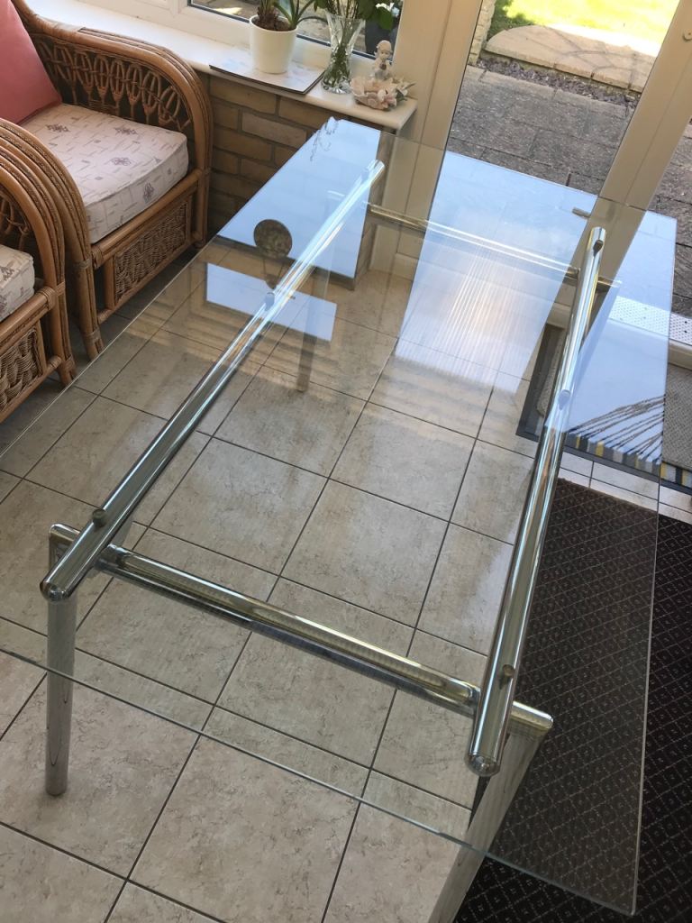 Elegant glass dining table with chrome base