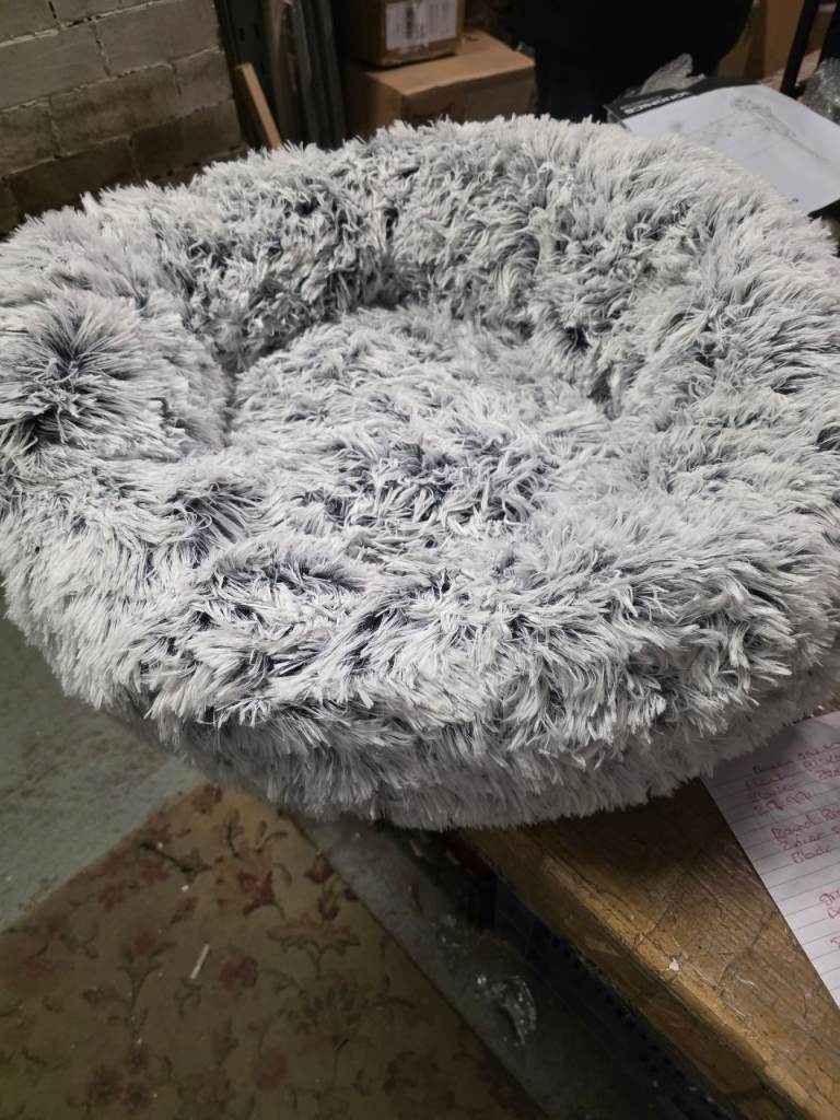 A new meduim fluffy grey pet bed with antislip back