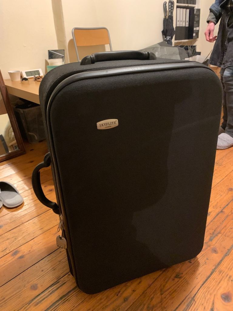 Black wheeled suitcase URGENT until 26th March