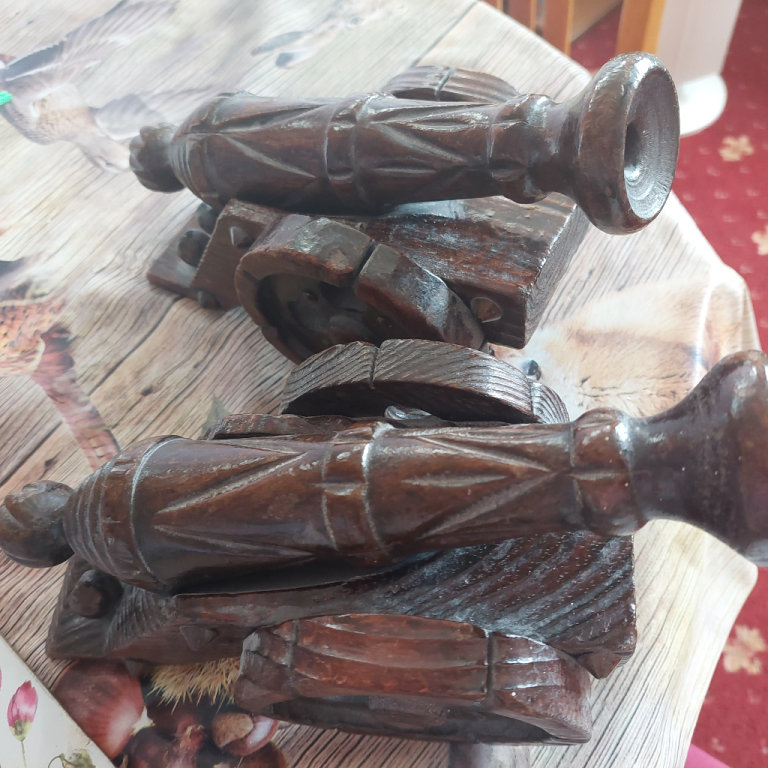 Two small wooden carved canons 