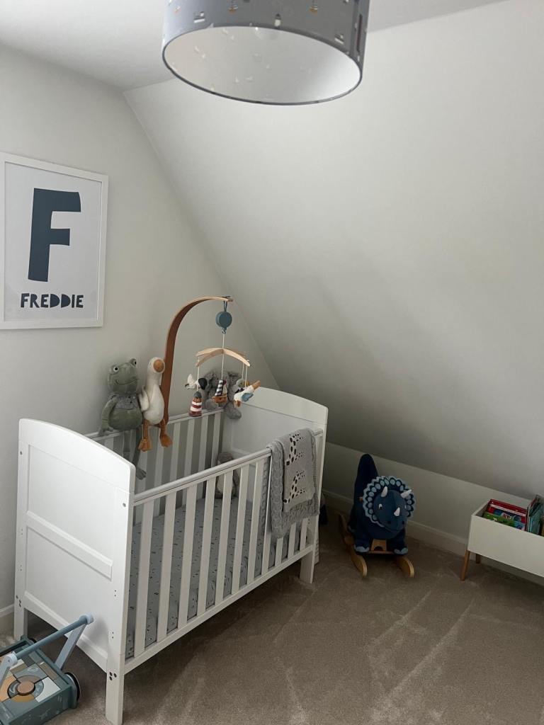 Pristine white wooden cot with mattress
