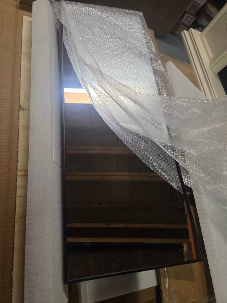 A new still boxed black rimmed over a door mirror the measurements 