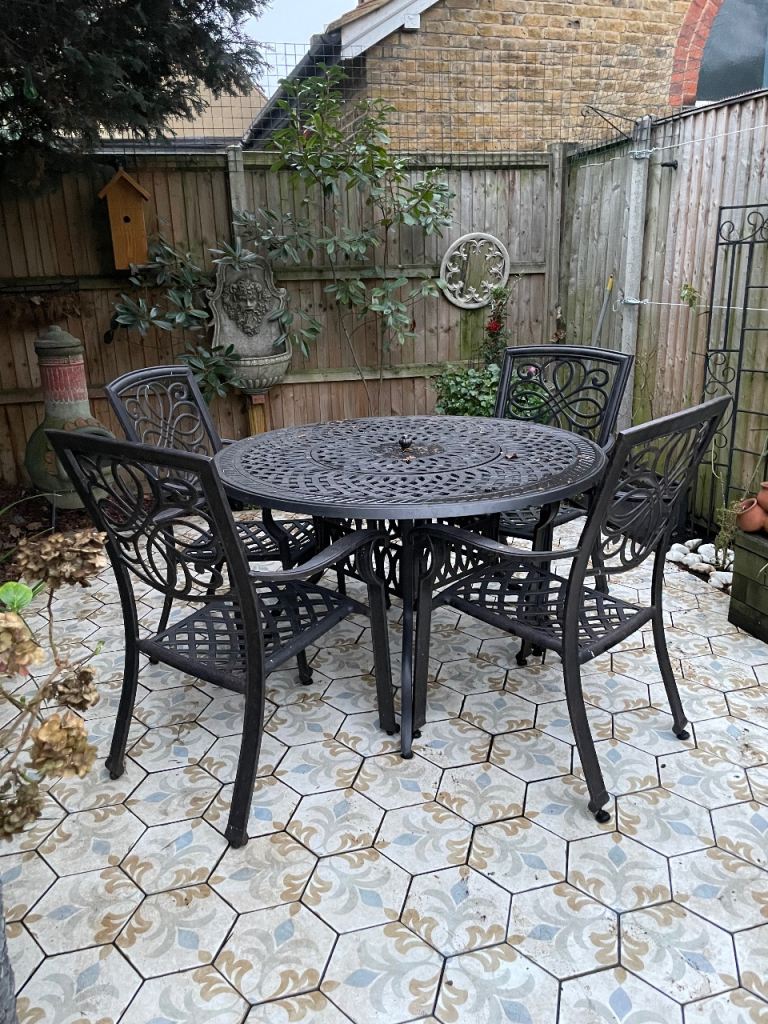 Garden dining table with fire pit and chairs