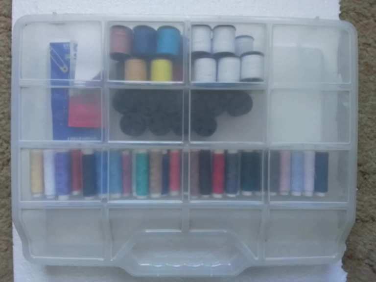 Approx 90 assorted sewing cottons and some sewing needles in a Plastic carrying case
