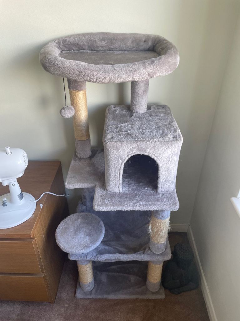 Grey multi-level cat tree with scratching posts and bed