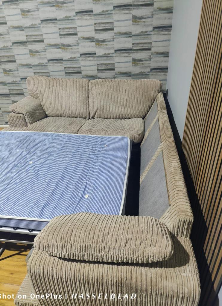 Large beige DFS Corner Sofa Bed  with footstool + free delivery