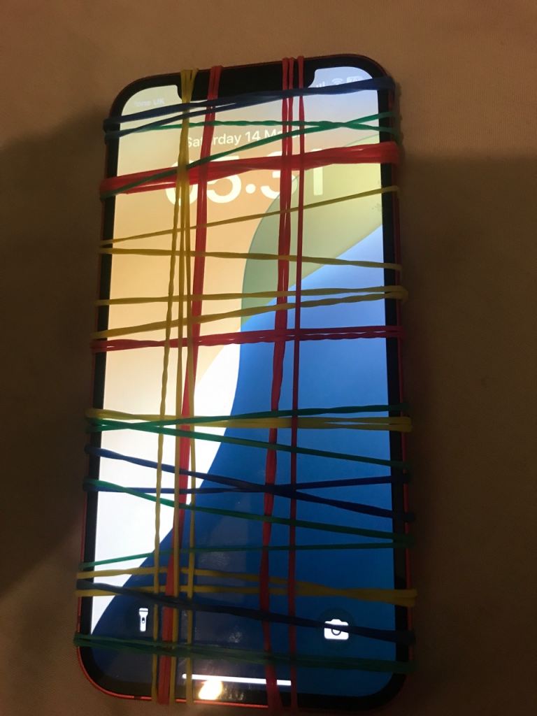 Apple iPhone 12 unlocked another 20 hours left with the rubber bands and we will take it off 