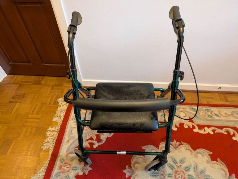 Upright mobility walker with seat and bag. 
