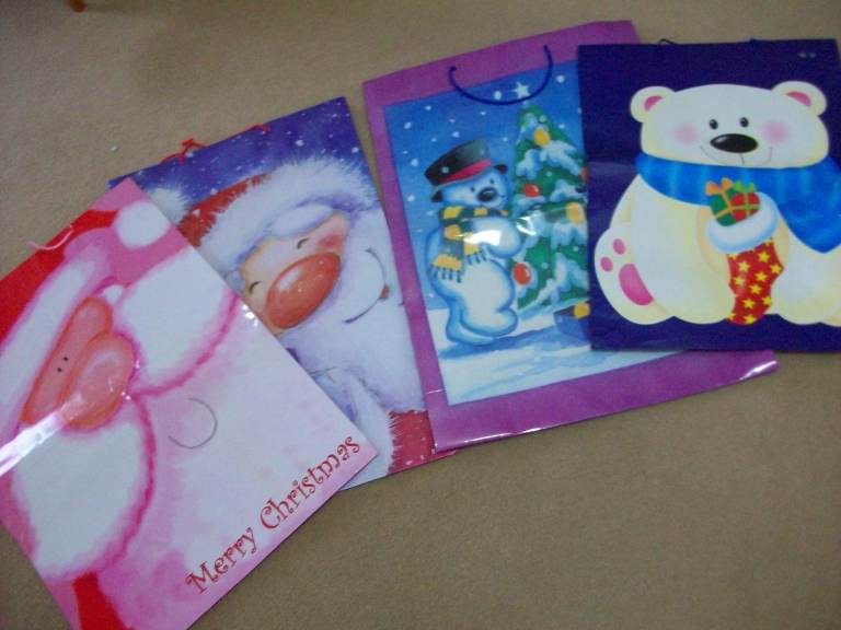 FOUR LARGE CHRISTMAS GIFT BAGS