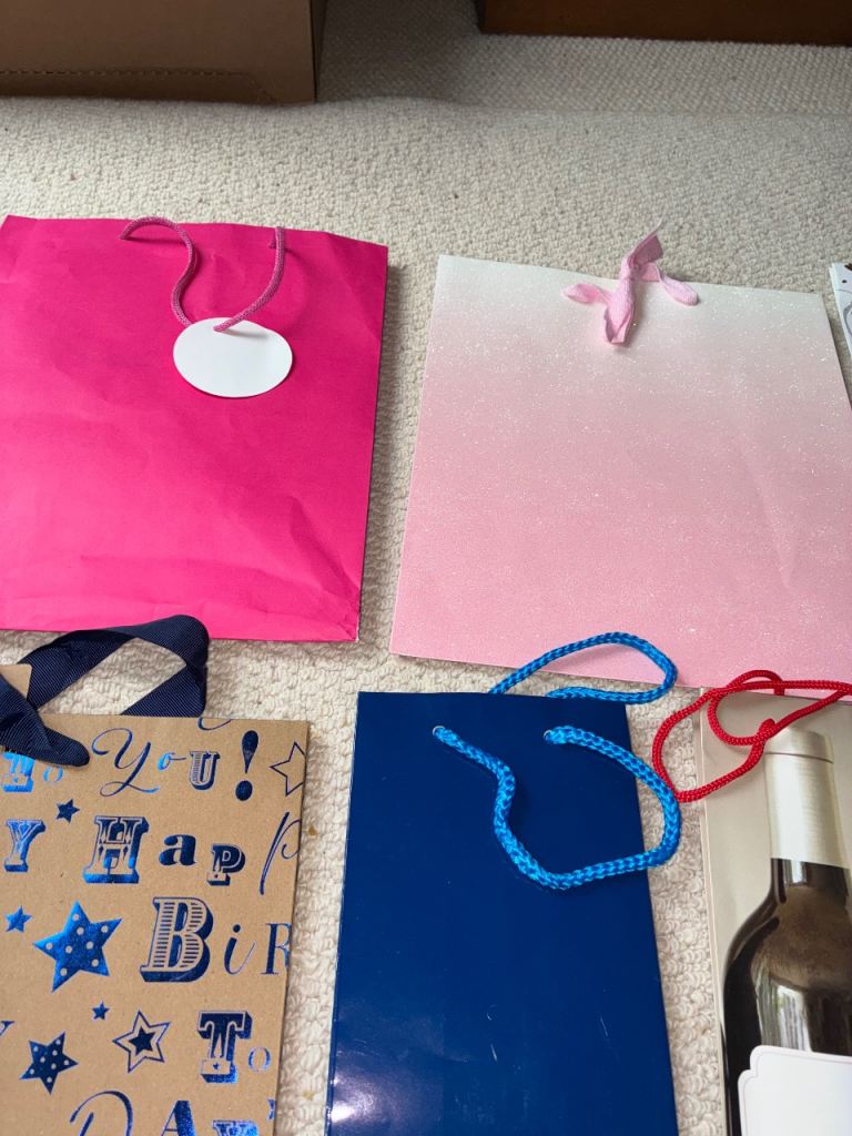 Large selection various sized gift bags, ribbons