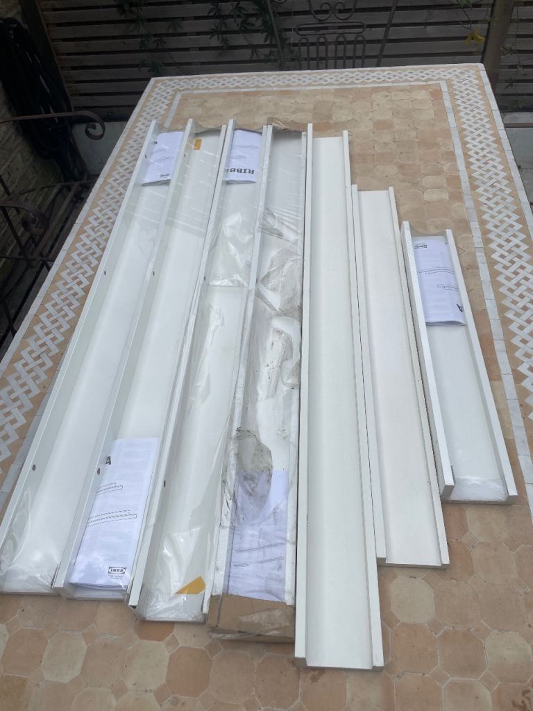 Seven ikea Ribba picture shelves most unused