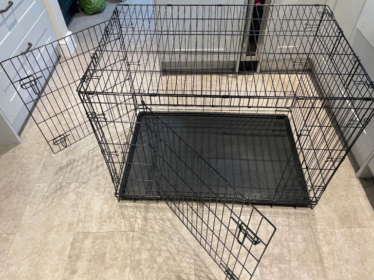 Black metal dog crate with removable tray