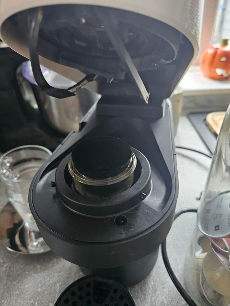 Nespresso veturo pod coffee maker machine in white with Nespresso cups/saucers, storage jar and pods