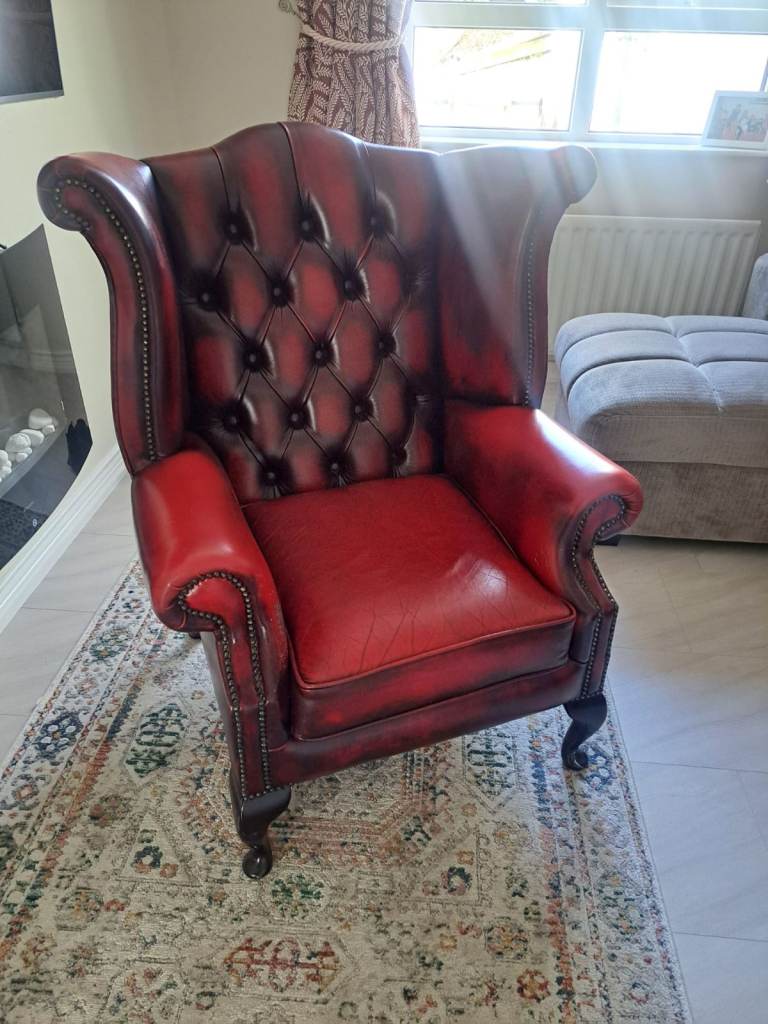 FREE wing-back, ox blood leather armchair.