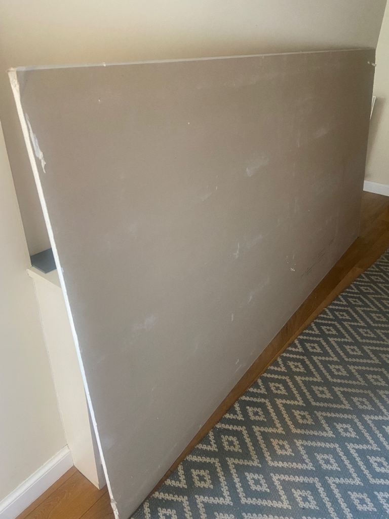 Damaged sheet of plasterboard and just under half sheet
