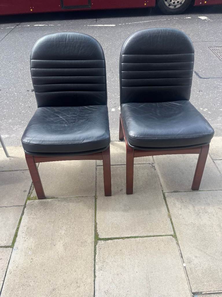 A Pair of Vintage chairs with wooden frames.