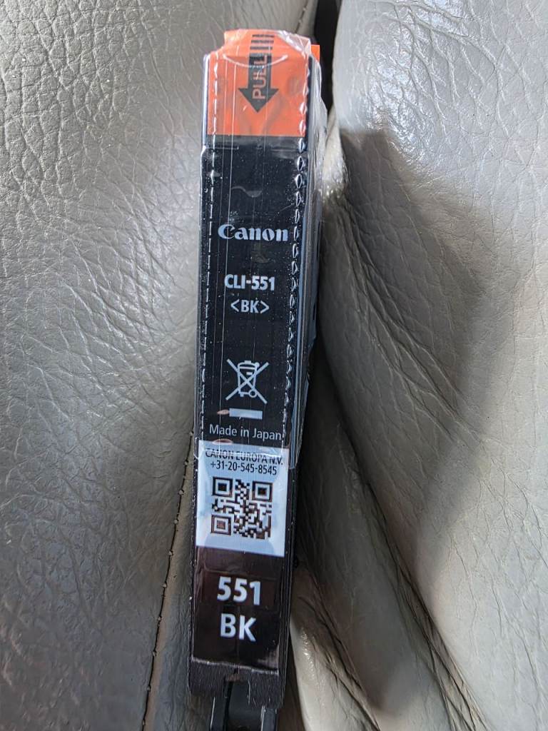 Two original Canon CLI 551 BK black ink cartridges.