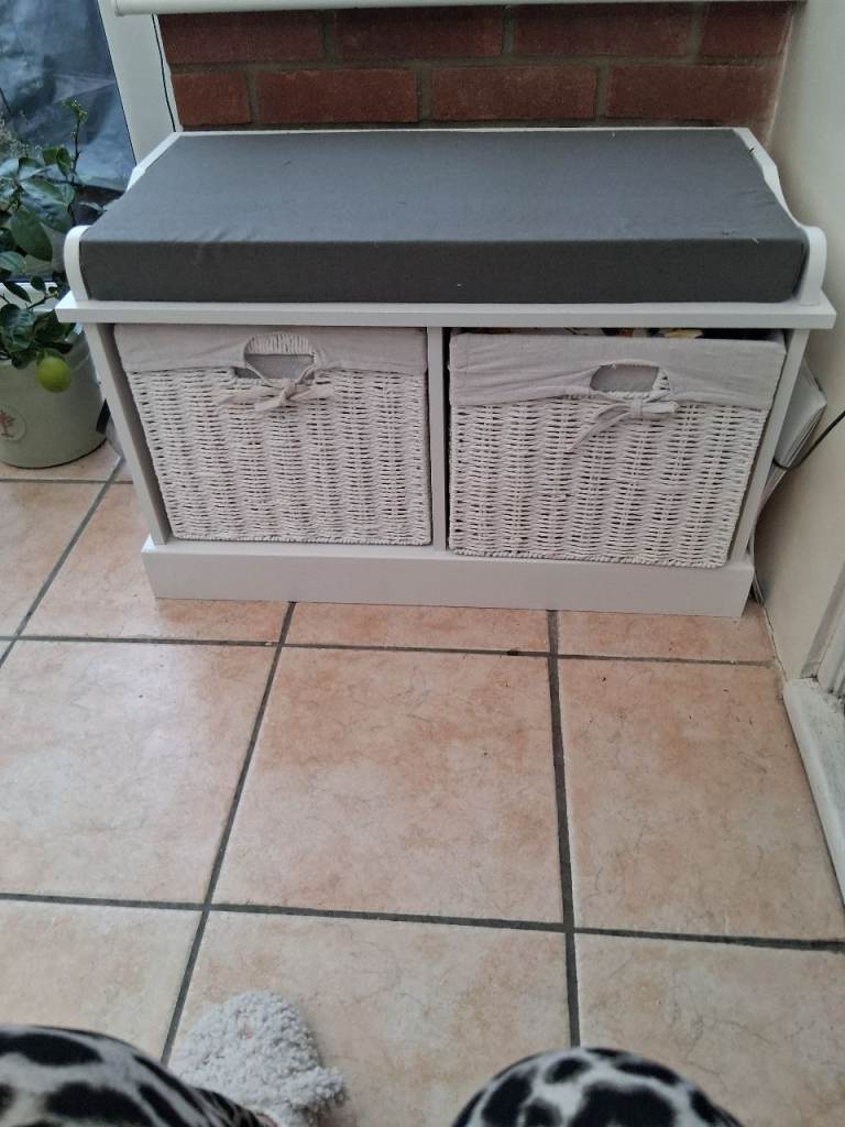 White wooden storsge unit with baskets and cushions 