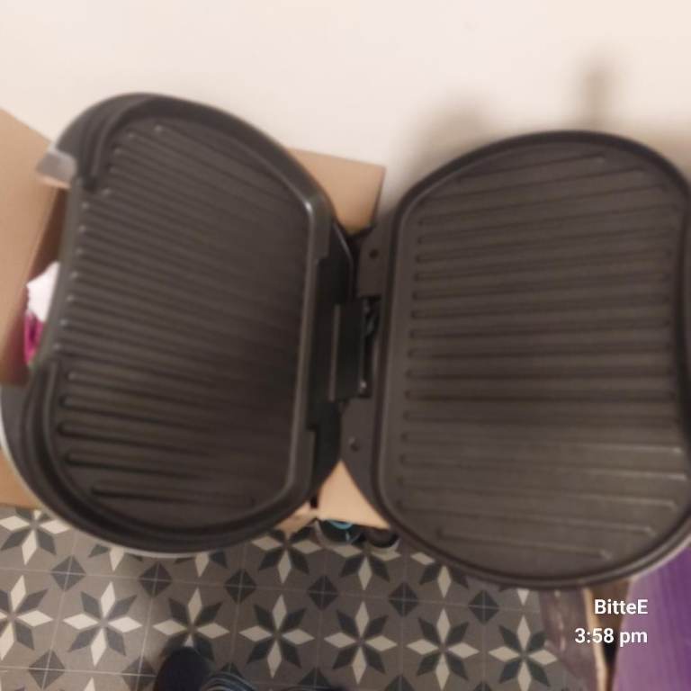 A brand new Russell Hobbs Satin Grill in its original packaging